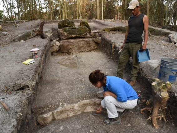 Two people excavating an archaeological site